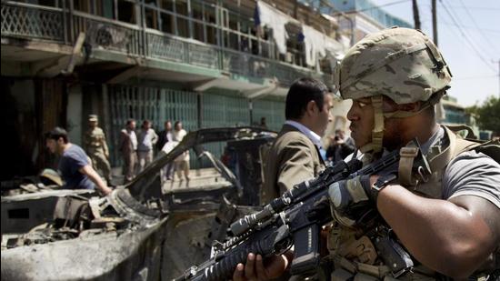 A US soldier arrives at the scene where a suicide car bomber attacked a NATO convoy in Kabul, Afghanistan on May 16, 2013. (AP) A US soldier arrives at the scene where a suicide car bomber attacked a NATO convoy in Kabul, Afghanistan on May 16, 2013. (AP)