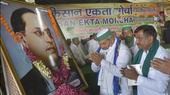 Bharatiya Kisan Union (BKU) leader Rakesh Tikait paying tribute to Dr BR Ambedkar on his 130th birth anniversary, at the Ghazipur border farmers’ protest site, in New Delhi on Wednesday . (HT Photo) Bharatiya Kisan Union (BKU) leader Rakesh Tikait paying tribute to Dr BR Ambedkar on his 130th birth anniversary, at the Ghazipur border farmers’ protest site, in New Delhi on Wednesday . (HT Photo)