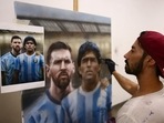 Argentine artist Maximiliano Bagnasco finishes a painting of soccer legend Diego Armando Maradona, and Barcelona's footballer Lionel Messi, at his workshop, in Buenos Aires, Argentina. 