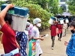 Polling workers carry EVMs and other polling materials to a distribution center on the eve of the fifth phase of West Bengal Assembly election, in Kolkata on Friday. (ANI Photo )