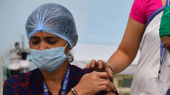 A medical worker inoculates a colleague with a Covid-19 coronavirus vaccine, Mumbai. A medical worker inoculates a colleague with a Covid-19 coronavirus vaccine, Mumbai.