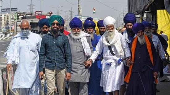 Farmers walk at the site during their ongoing protest against new farm laws at Delhi Ghazipur-border, in Delhi. (File photo) Farmers walk at the site during their ongoing protest against new farm laws at Delhi Ghazipur-border, in Delhi. (File photo)