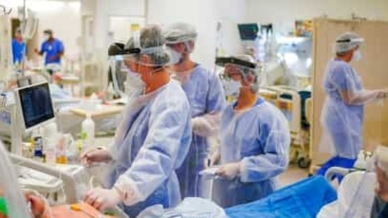 Health workers tend to a Covid-19 patient in the ICU ward at the Hospital das Clinicas in Porto Alegre, Brazil (AP). Health workers tend to a Covid-19 patient in the ICU ward at the Hospital das Clinicas in Porto Alegre, Brazil (AP).