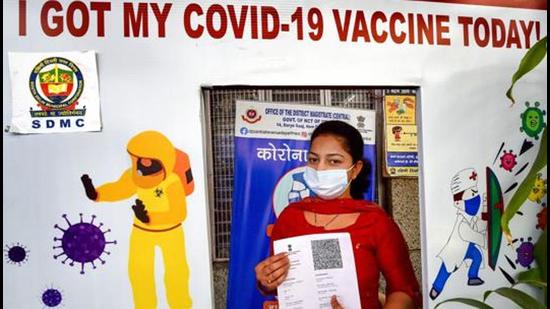 A woman poses for photographs after receiving a dose of Covid-19 vaccine, at SDMC Urban Public Health Centre Daryaganj, in New Delhi. (File photo)