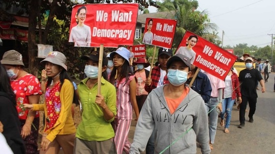 Protesters marching ahead holding signs with portraits of detained Myanmar civilian leader Aung San Suu Kyi during a demonstration against the military coup in Launglon township in Dawei. (AFP Photo) Protesters marching ahead holding signs with portraits of detained Myanmar civilian leader Aung San Suu Kyi during a demonstration against the military coup in Launglon township in Dawei. (AFP Photo)