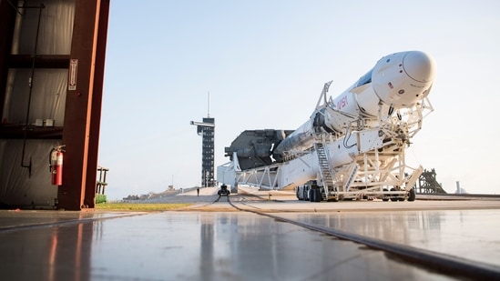 In this image released by NASA, a SpaceX Falcon 9 rocket with the company's Crew Dragon spacecraft onboard is rolled out of the horizontal integration facility.(AFP)