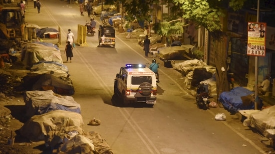 A police vehicle patrols outside Vile Parle station during night curfew in Mumbai. (PTI Photo ) A police vehicle patrols outside Vile Parle station during night curfew in Mumbai. (PTI Photo )