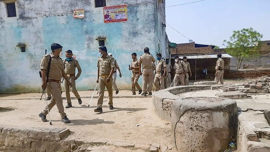 Police personnel in action after alleged loot of ballot boxes following clashes between two groups during Panchayat polls, in Agra.(PTI) Police personnel in action after alleged loot of ballot boxes following clashes between two groups during Panchayat polls, in Agra.(PTI)