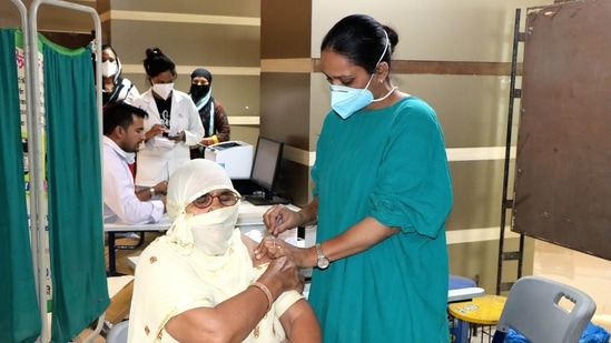 A medical professional administering vaccine to a woman. (Manoj Dhaka/HT photo for representation)