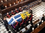 Queen Elizabeth II watches as pallbearers carry the coffin of Prince Philip during his funeral at St George's Chapel, Windsor Castle.(Reuters)
