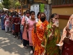 People in queues to cast their vote showing voter ID cards during the fifth phase of West Bengal Assembly Election 2021 in Salt Lake.(Samir Jana/HT Photo)