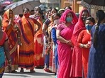 Voters stand in a queue at a polling station to cast their ballot during the 5th phase of West Bengal's state legislative assembly elections in Kolkata. (AFP)