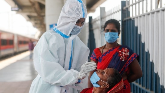 A healthcare worker in personal protective equipment (PPE) collects a swab sample from a woman, amidst the spread of the coronavirus disease (COVID-19), at a railway station in Mumbai, India, April 16, 2021. REUTERS/Francis Mascarenhas (REUTERS)