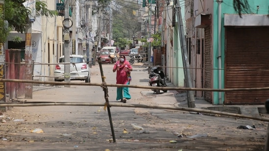 Jaipur: Bamboo poles placed as barricading to keep people inside an area declared a Covid-19 containment zone at Malviya Nagar, in Jaipur, Rajasthan, India on Wednesday, April 14, 2021. (Himanshu Vyas / HT Photo)