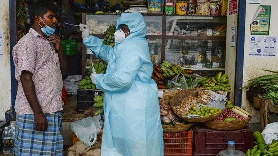 A health worker taking a swab sample from a shopkeeper for a RT-PCR Covid-19 coronavirus test in Chennai on April 10. As per the health ministry, 10 states - Maharashtra, Chhattisgarh, Uttar Pradesh, Delhi, Karnataka, Tamil Nadu, Kerala, Madhya Pradesh, Gujarat and Rajasthan - are showing a steep rise in daily Covid-19 cases. They accounted for 82.82% of the new infections on April 10.(Arun Sankar / AFP)