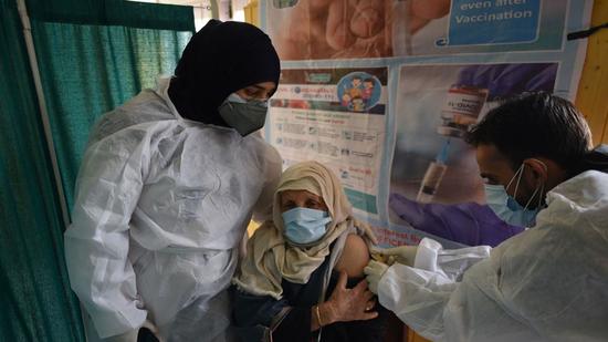 A Kashmiri woman receives a shot of Covid-19 vaccine in Srinagar on Saturday. (Waseem Andrabi/HT) A Kashmiri woman receives a shot of Covid-19 vaccine in Srinagar on Saturday. (Waseem Andrabi/HT)