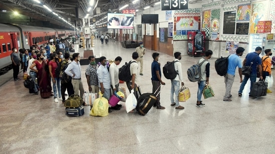 Migrants arriving from Maharashtra wait in a queue for Covid-19 test at Patna railway station.