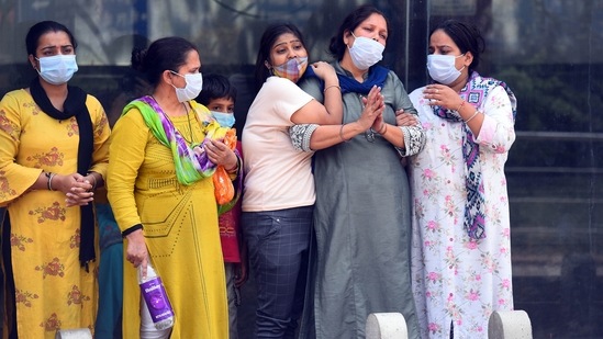 Relatives and family members of a person who died of Covid-19, break down during the cremation, at Nigambodh Ghat crematorium on April 16. Six hospitals are attached with the Nigambodh Ghat--one of the biggest crematoriums in the city for Covid-related funerals. Suman Gupta, the general secretary of Badi Panchayat Vaishya Beese Agarwal organisation that manages the city’s main crematorium at the ghat, said around 120 bodies were cremated on April 15, which is the highest number of cremations so far this year.(Raj K Raj / HT Photo)