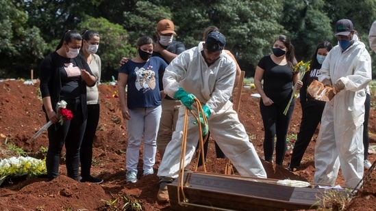 People attend the burial of a relative who died from complications related to Covid-19 at the Vila Formosa cemetery in Sao Paulo, Brazil. (AP Photo) People attend the burial of a relative who died from complications related to Covid-19 at the Vila Formosa cemetery in Sao Paulo, Brazil. (AP Photo)