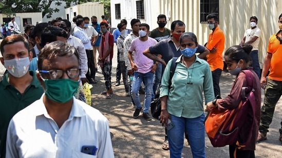 People wait for their turn to get tested for the Covid-19 disease in Mumbai on April 16, 2021. 