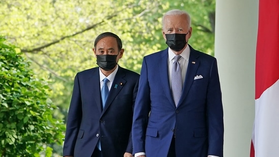 US President Joe Biden and Japan's Prime Minister Yoshihide Suga walk through the Colonnade to take part in a joint press conference in the Rose Garden of the White House in Washington. (AFP)