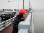 Volunteer Chen Si looks out at the Yangtze river from the Nanjing bridge in Jiangsu province, China on April 2. Chen has patrolled the 3.2 km long Nanjing bridge soaring above China's Yangtze river in Nanjing for some 18 years, determined to stop the desperate from jumping into the swirling waters below.(Wang Zhao / AFP)