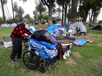 A homeless man pushes his belongings at a homeless encampment at Echo Park Lake in Los Angeles, California. (AFP) A homeless man pushes his belongings at a homeless encampment at Echo Park Lake in Los Angeles, California. (AFP)