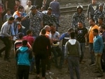 Medics carry an injured man at the site where a passenger train derailed injuring at least 100 people, in Banha, Qalyubia province, Egypt, Sunday(AP Photo ) Medics carry an injured man at the site where a passenger train derailed injuring at least 100 people, in Banha, Qalyubia province, Egypt, Sunday(AP Photo )