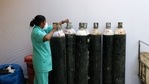 A health worker checks oxygen cylinders at a makeshift Covid-19 quarantine facility set up in a banquet hall in New Delhi, India. (Bloomberg) A health worker checks oxygen cylinders at a makeshift Covid-19 quarantine facility set up in a banquet hall in New Delhi, India. (Bloomberg)
