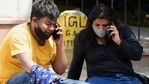 Family members on their phones as they react to the death of a relative outside Lok Nayak hospital on Sunday afternoon.(PTI) Family members on their phones as they react to the death of a relative outside Lok Nayak hospital on Sunday afternoon.(PTI)