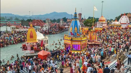 Social distancing norms were violated during the third 'Shahi Snan' at the Kumbh Mela in Haridwar on April 14, 2021. (PTI Photo) Social distancing norms were violated during the third 'Shahi Snan' at the Kumbh Mela in Haridwar on April 14, 2021. (PTI Photo)