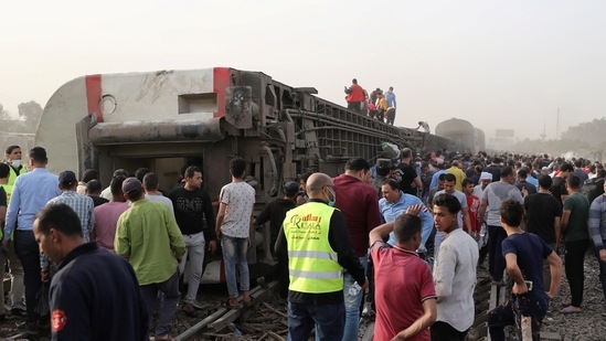 People gather at the site where train carriages derailed in Qalioubia province, north of Cairo, Egypt.(Reuters)