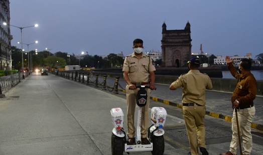 A police personnel patrolling on a segway near Gateway of India before a statewide lockdown to check the spread of Covid-19, at Colaba, in Mumbai. (Bhushan Koyande/ HT Photo) A police personnel patrolling on a segway near Gateway of India before a statewide lockdown to check the spread of Covid-19, at Colaba, in Mumbai. (Bhushan Koyande/ HT Photo)
