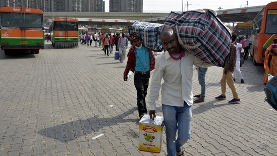 Migrant workers and other travellers leaving the city as Covid-19 cases in the NCR region rise, at Kaushambi Bus Terminal in Ghaziabad.(Sakib Ali / HT Photo) Migrant workers and other travellers leaving the city as Covid-19 cases in the NCR region rise, at Kaushambi Bus Terminal in Ghaziabad.(Sakib Ali / HT Photo)