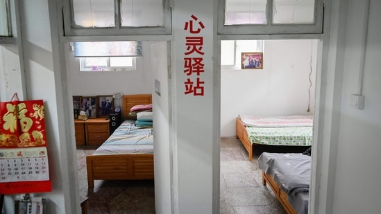Bedrooms for those being helped by Chen Si, at his office in Nanjing, Jiangsu province, on April 1. Based out of a small office, with the motto "Cry when you need to cry" painted on the wall, Chen converted two rooms into dorms for desperate people without a place to sleep.(Wang Zhao / AFP)