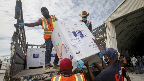 Boxes of AstraZeneca Covid-19 vaccine manufactured by the Serum Institute of India and provided through the global COVAX initiative arrive at the airport in Mogadishu, Somalia on March 15. The WHO recently described the vaccine supply situation as precarious. Up to 60 countries might not receive any more shots until June, by one estimate. To date, COVAX has delivered about 40 million doses to more than 100 countries, enough to cover barely 0.25% of the world’s population. (Farah Abdi Warsameh / AP)