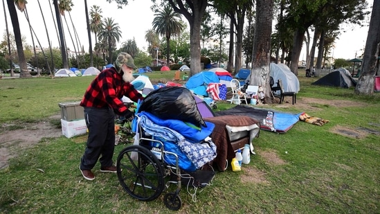 A homeless man pushes his belongings at a homeless encampment at Echo Park Lake in Los Angeles, California. (AFP) A homeless man pushes his belongings at a homeless encampment at Echo Park Lake in Los Angeles, California. (AFP)