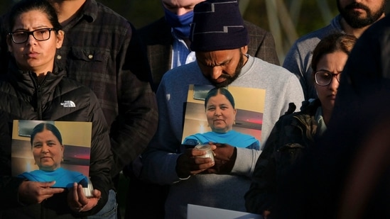 Family members hold a photo of their loved one during a candlelight vigil in Krannert Park in Indianapolis, Indiana on April 17, 2021, (AFP Photo) Family members hold a photo of their loved one during a candlelight vigil in Krannert Park in Indianapolis, Indiana on April 17, 2021, (AFP Photo)
