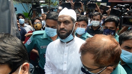 Police escort Mamunul Haque, a joint secretary of hardline Islamist group Hefazat-e-Islam, following his arrest in Dhaka on April 18, 2021.(AFP)