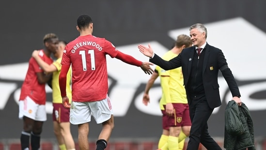Manchester United's manager Ole Gunnar Solskjaer greets Manchester United's Mason Greenwood at the end of the English Premier League soccer match between Manchester United and Burnley at the Old Trafford stadium in Manchester, England, Sunday, April 18, 2021. (Gareth Copley/Pool via AP) (AP) Manchester United's manager Ole Gunnar Solskjaer greets Manchester United's Mason Greenwood at the end of the English Premier League soccer match between Manchester United and Burnley at the Old Trafford stadium in Manchester, England, Sunday, April 18, 2021. (Gareth Copley/Pool via AP) (AP)