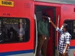 A health worker screens a passenger at a Dadar railway station during restrictions imposed by the Maharashtra government amidst rising Covid-19 cases. (Bhushan Koyande/HT Photo)