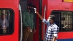 A health worker screens a passenger at a Dadar railway station during restrictions imposed by the Maharashtra government amidst rising Covid-19 cases. (Bhushan Koyande/HT Photo) A health worker screens a passenger at a Dadar railway station during restrictions imposed by the Maharashtra government amidst rising Covid-19 cases. (Bhushan Koyande/HT Photo)