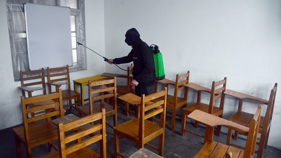 A worker sanitizes the classrooms ahead of the opening of schools after the COVID-19 outbreak, in Srinagar on Saturday. (ANI Photo)