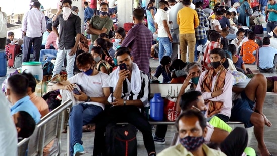 Passengers wait at the station as they arrive to board the train for their hometown amid the surge in Covid-19 cases, at Anand Vihar Railway Station in New Delhi.(ANI)