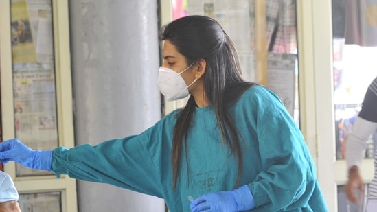 A health worker collecting swab samples from people for Covid-19 test in Chandigarh (Keshav Singh/HT Photo). A health worker collecting swab samples from people for Covid-19 test in Chandigarh (Keshav Singh/HT Photo).