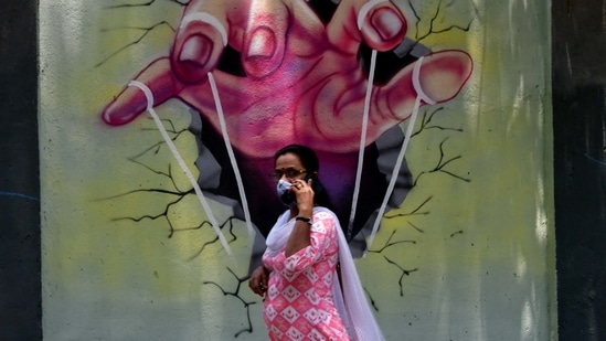 A person walk past a mural, at Parel Village, in Mumbai.(HT photo)
