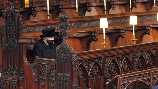 Britain's Queen Elizabeth II sits alone in St. George's Chapel during the funeral of Prince Philip, the man who had been by her side for 73 years, at Windsor Castle, Windsor, England, on Saturday, April 17, 2021. (AP)