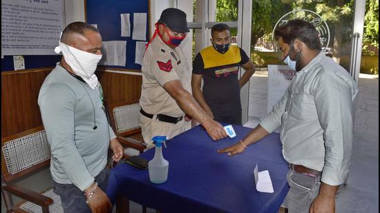 Visitors being screened outside the Ludhiana MC office on Monday. (GURPREET SINGH/HT)