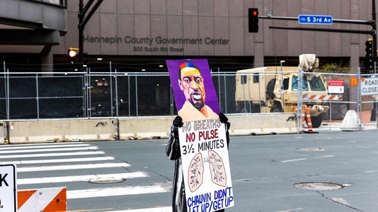A protester holds a sign outside the Courthouse before the closing arguments in Derek Chauvin's murder trial in Minneapolis, Minnesota. (AFP) A protester holds a sign outside the Courthouse before the closing arguments in Derek Chauvin's murder trial in Minneapolis, Minnesota. (AFP)