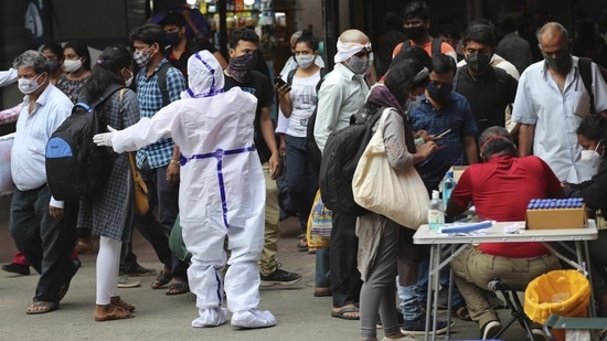 As many as 123,212 tests, comprising 9,591 rapid antigen and 113,621 RT-PCR, were conducted in Karnataka on Monday. In picture - Health worker directs arriving passengers towards Covid-19 testing counter outside a train station in Bengaluru. (AP) As many as 123,212 tests, comprising 9,591 rapid antigen and 113,621 RT-PCR, were conducted in Karnataka on Monday. In picture - Health worker directs arriving passengers towards Covid-19 testing counter outside a train station in Bengaluru. (AP)